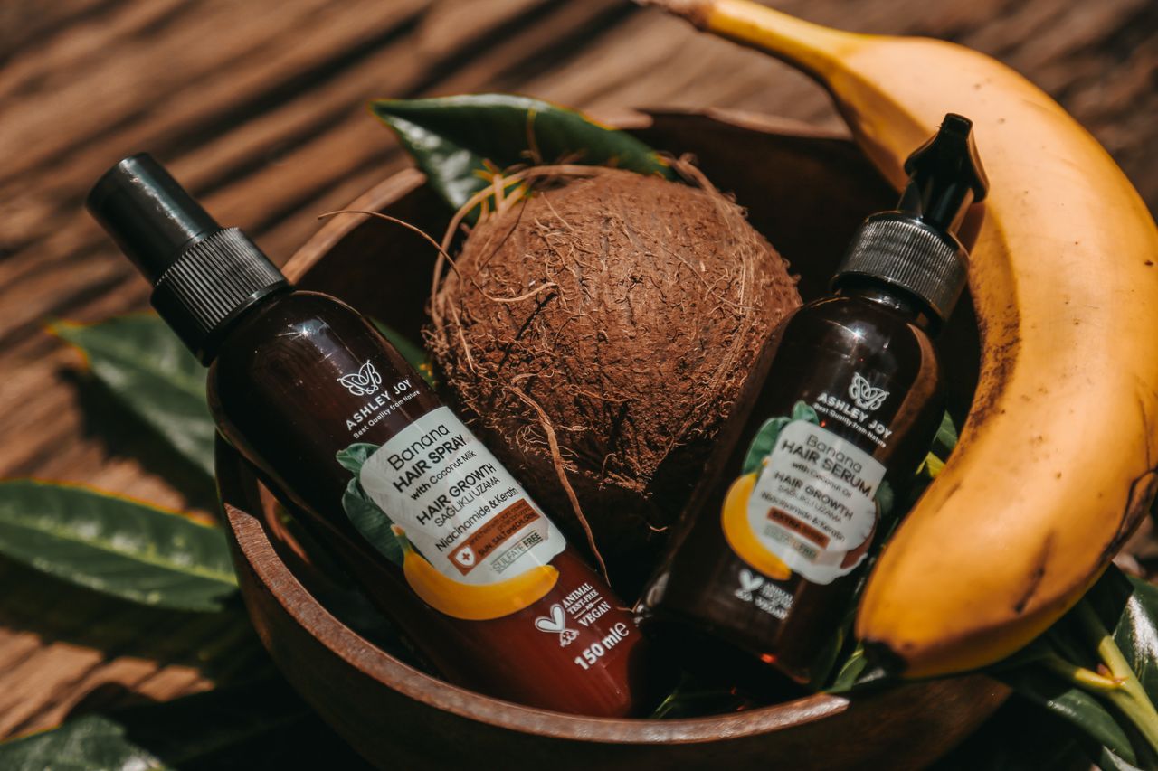 Tropical-themed hair products with banana and coconut for natural hair care display.